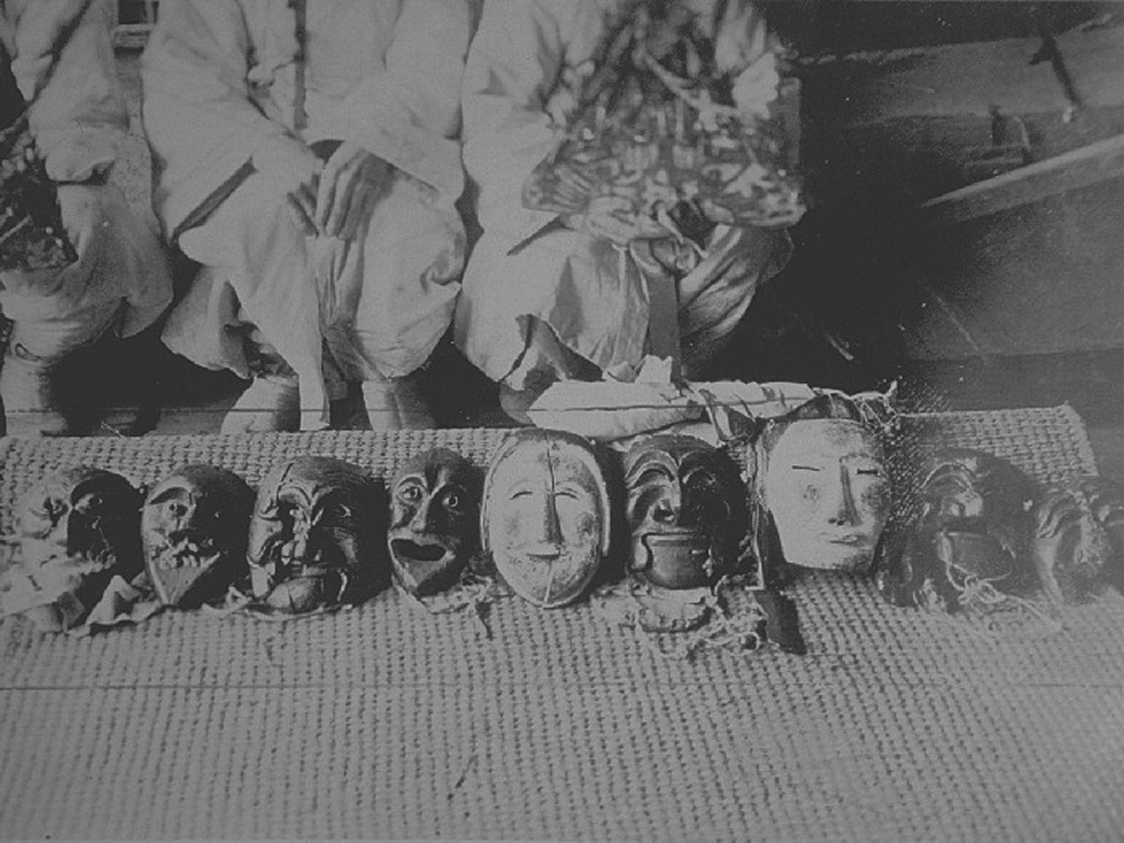 Ritual or performance context — masks in use