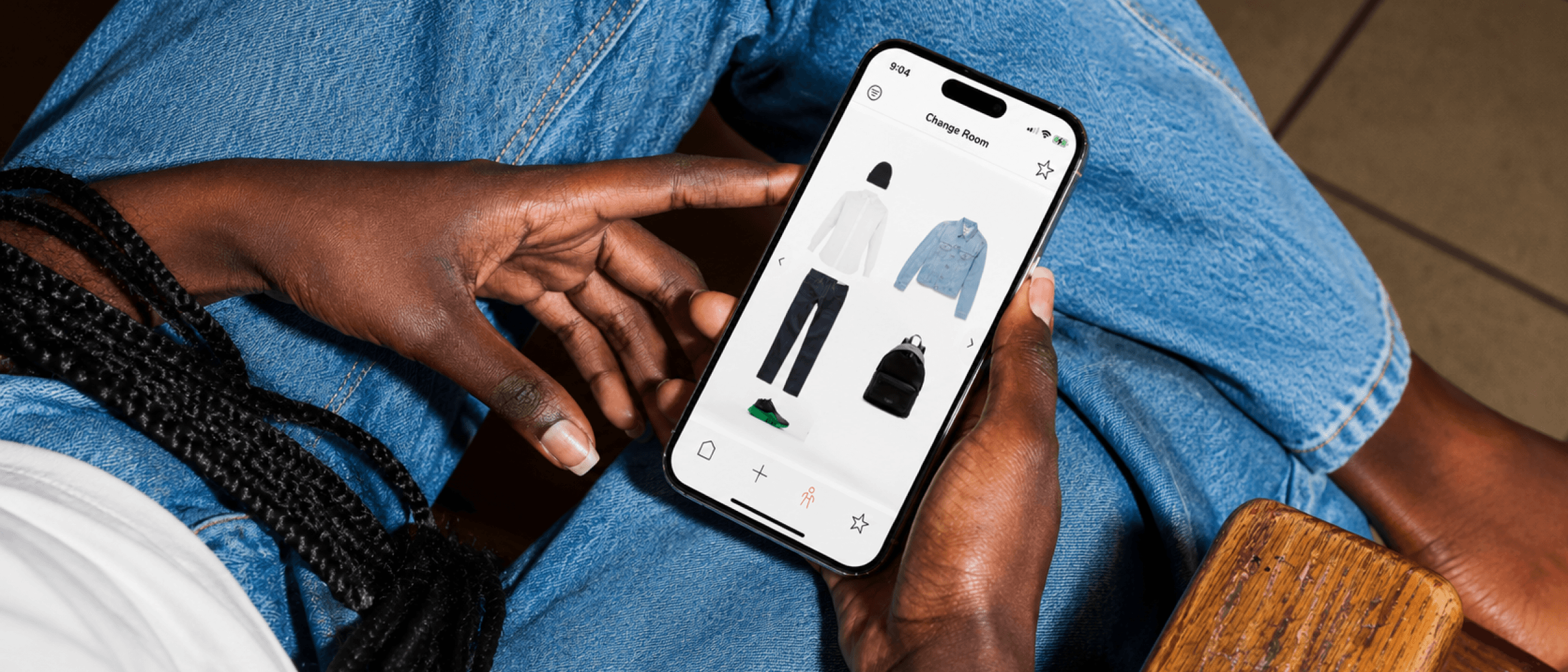Person using Lookscope app on iPhone in denim outfit